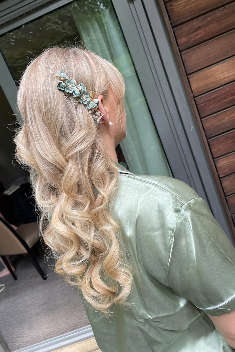 Bridesmaid curled hair with green hair accessory